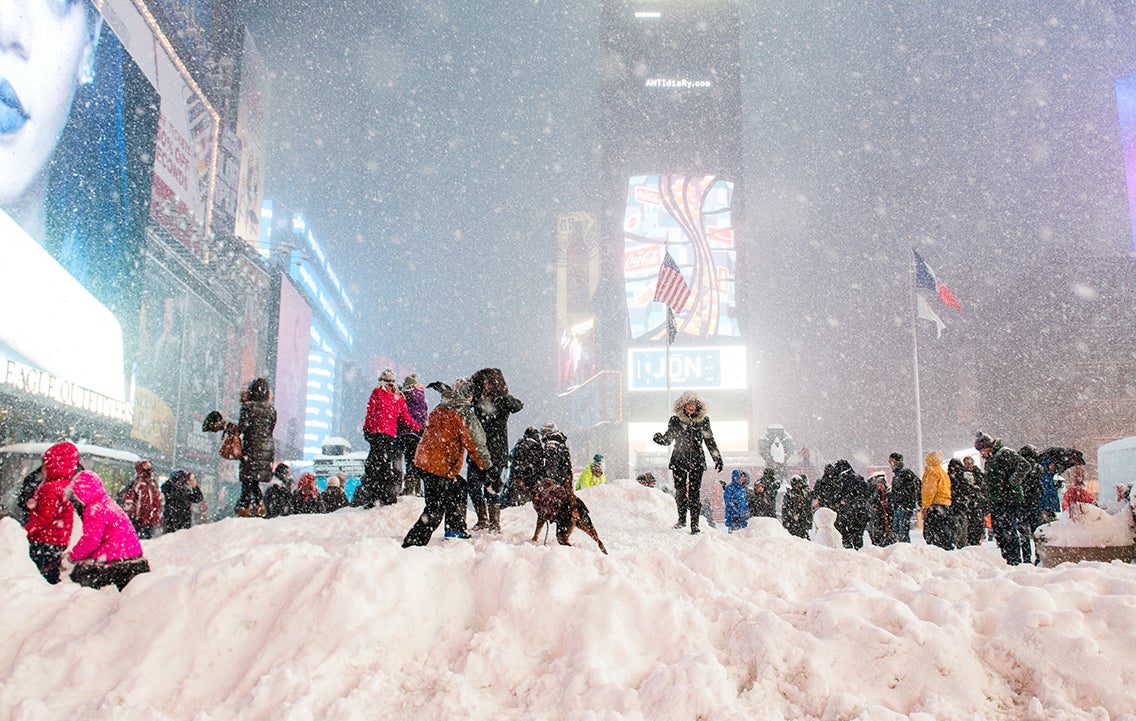 People walk in Times Square during a blizzard.