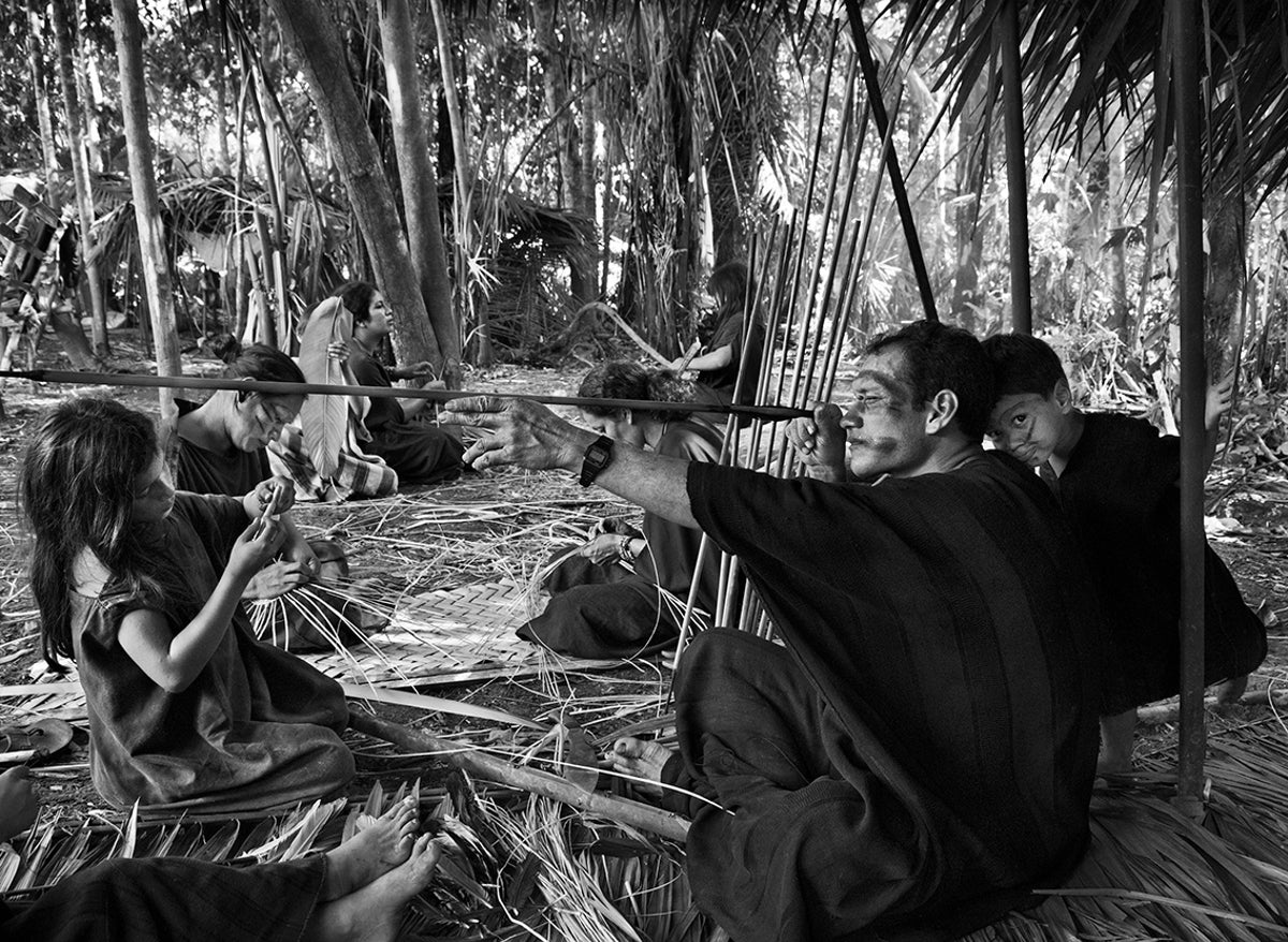 A member of the Indigenous Ashaninka people inspects an arrow.