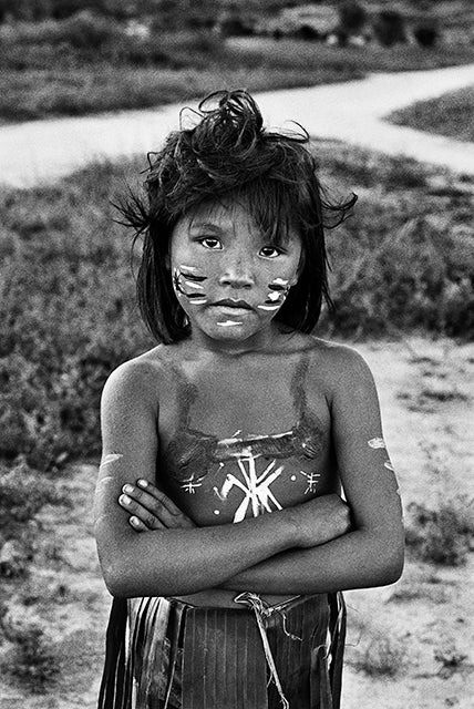 Indigenous child with her arms crossed.