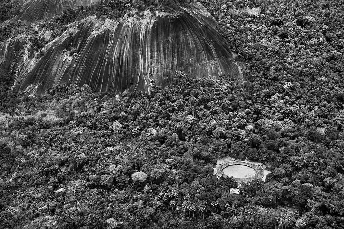  The village of Watoriki surrounded by lush, constructed in a ring encircling a central courtyard where celebrations and rituals are held.