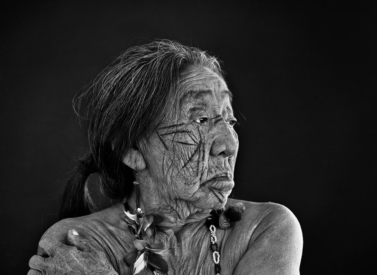 Elderly woman wearing traditional accessories.