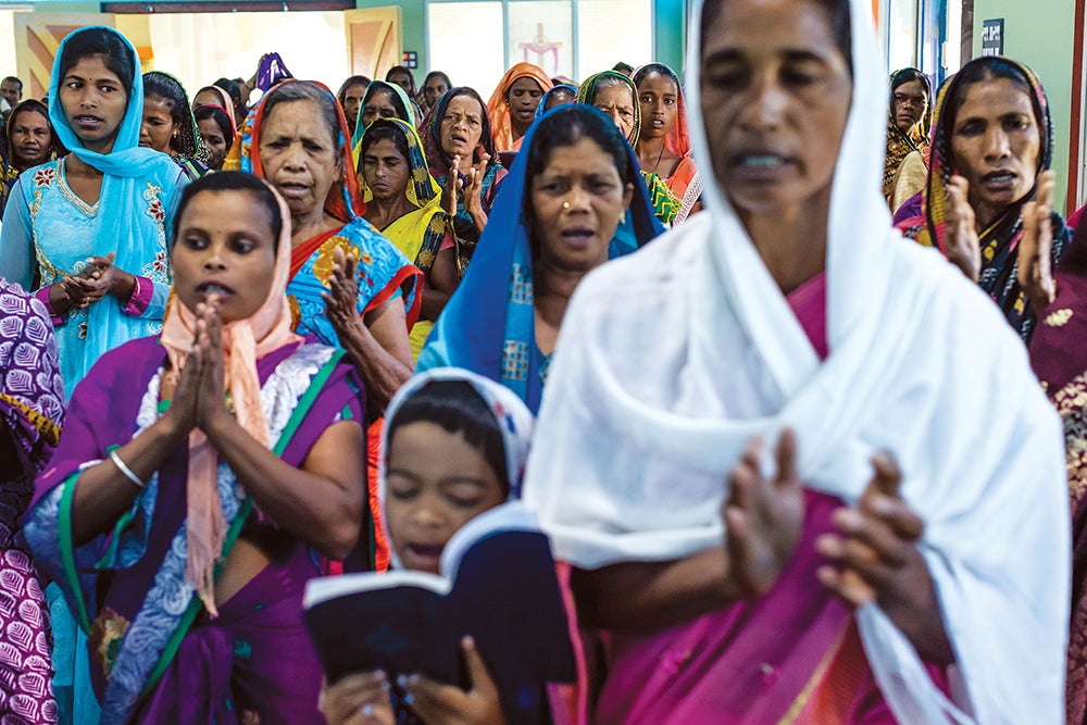 Sora women pray.