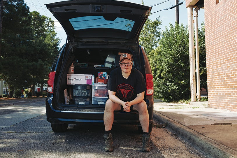 Loftin Wilson sitting in the back of an open van.