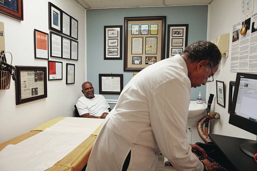 Doctor Edward Chapman treating a patient in his office.