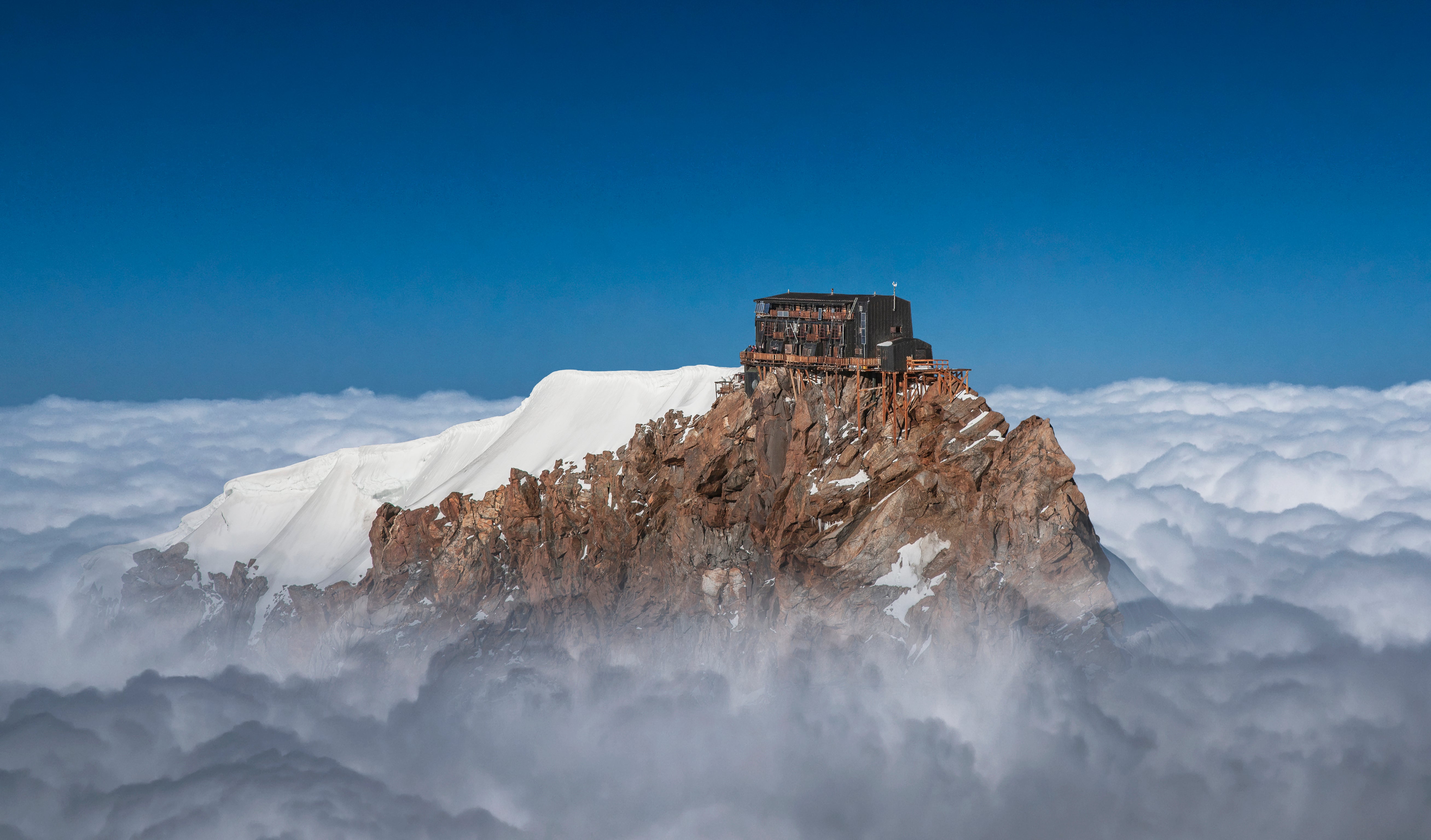 Alpine hut on a mountain top.