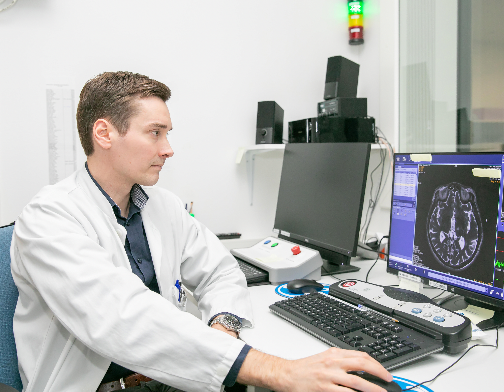 Juho Joutsa, a neurologist, at a desk.