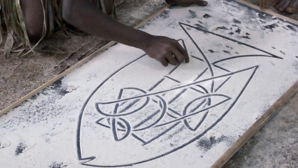 Sand drawing of a stylized fish