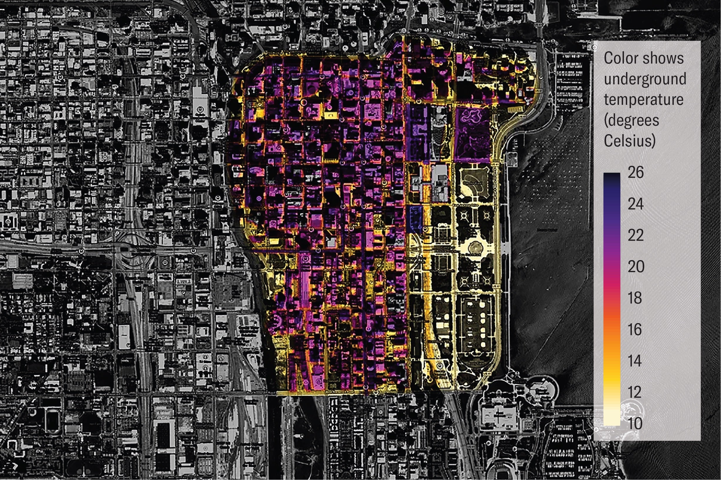 A mostly black and white aerial view of street grid. There are yellow and purple areas seen center-right, with the purple areas representing the highest temperatures.