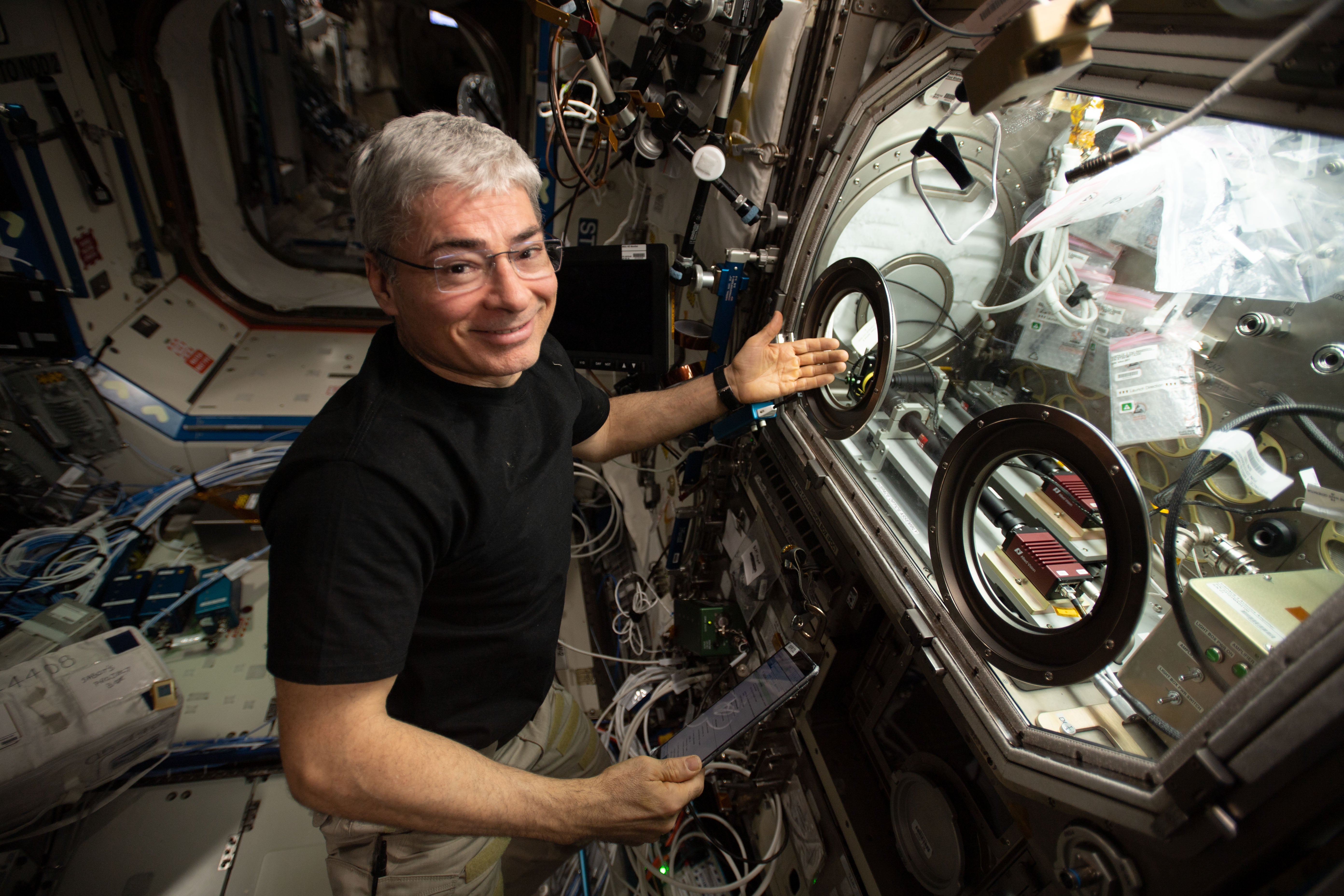 NASA astronaut Mark Vande Hei sets up an experiment inside the Microgravity Science Glovebox. 