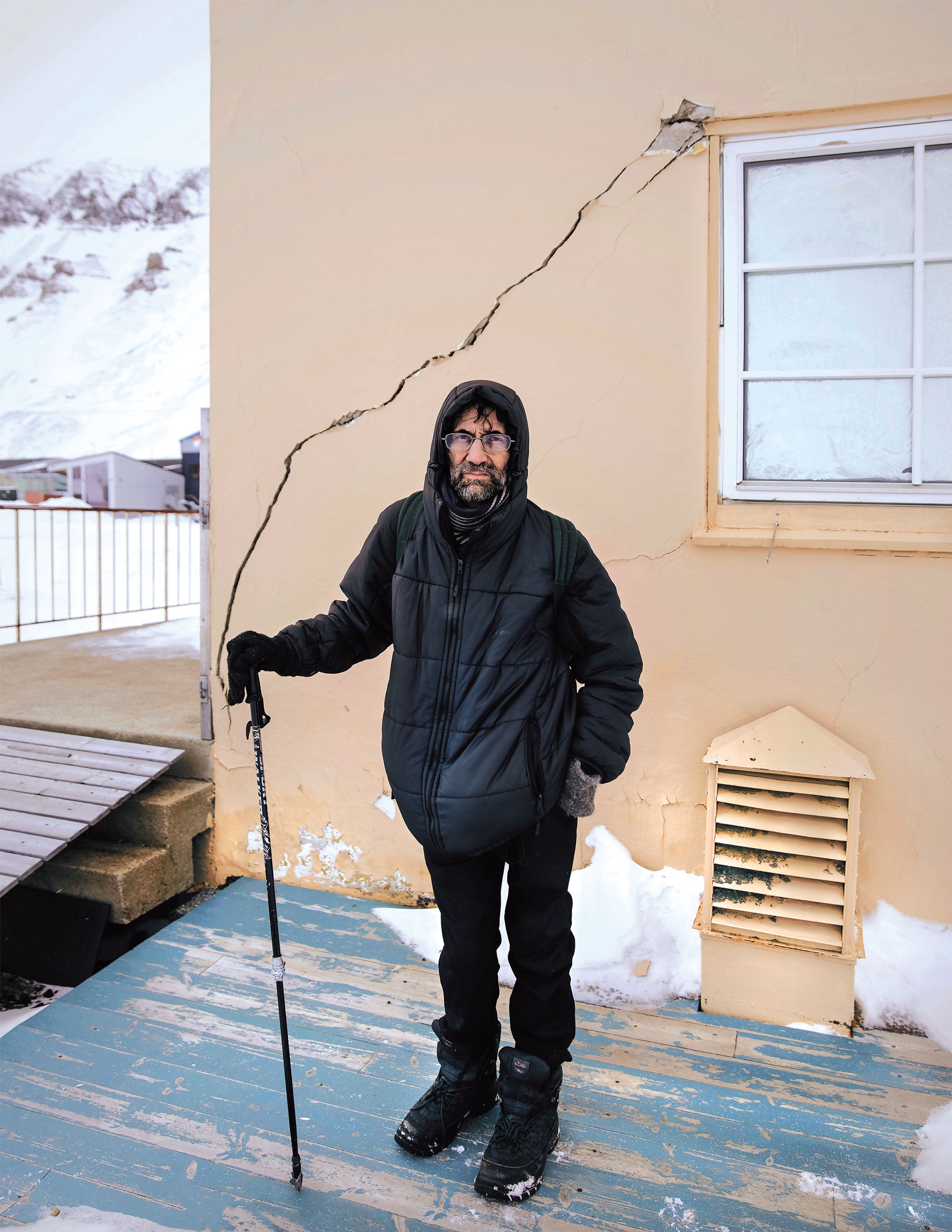 Mark Sabbatini standing outside a damaged apartment.