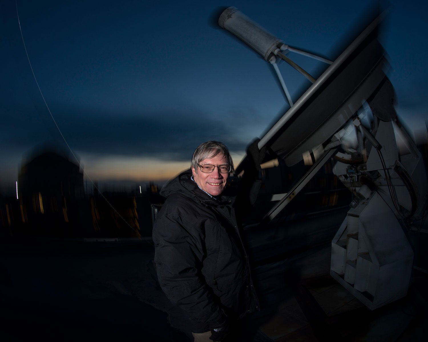 Professor Alan Guth, PhD of the MIT Physics Department with a radio telescope on the roof at MIT