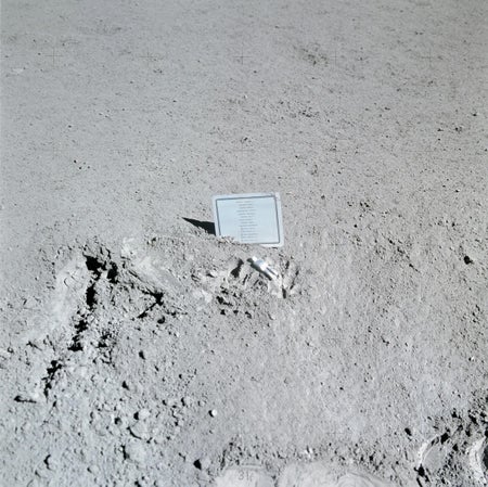 Plaque and tiny figurine on Moon's surface