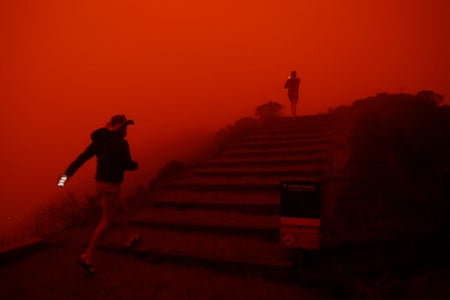 Red wildfire smoke filtered light, Thomas Spratley (right) and Paulo Santos of Sausalito visit the Marin Headlands in Sausalito,