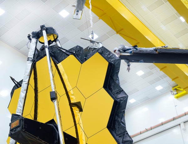 A technician checks the James Webb Space Telescope's 6.5-meter primary mirror.