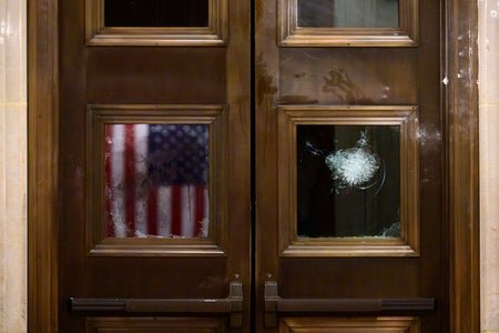 Door window reflecting American flag