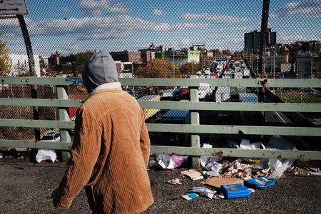 Person walking on overpass littered with trash