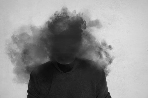 A person's head covered in dark clouds