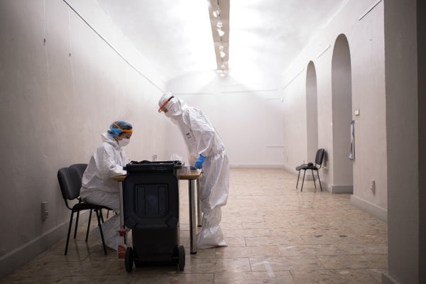 Health care workers process antigen tests for the COVID-19 virus on January 24, 2021, in Kosice, Slovakia.