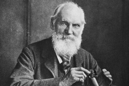 A bearded man in 19th century garb poses with some sort of scientific instrument.