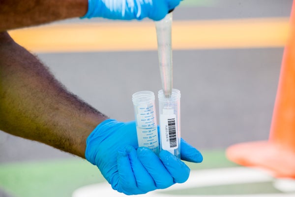 A Chelsea Water and Sewer Department worker performs a test on a wastewater sample for the presence of Covid-19 in Chelsea, Massachusetts, US, on Tuesday, July 27, 2021