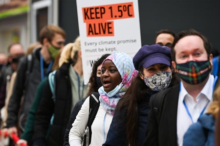 Protesters in front of orange 1.5 degree sign