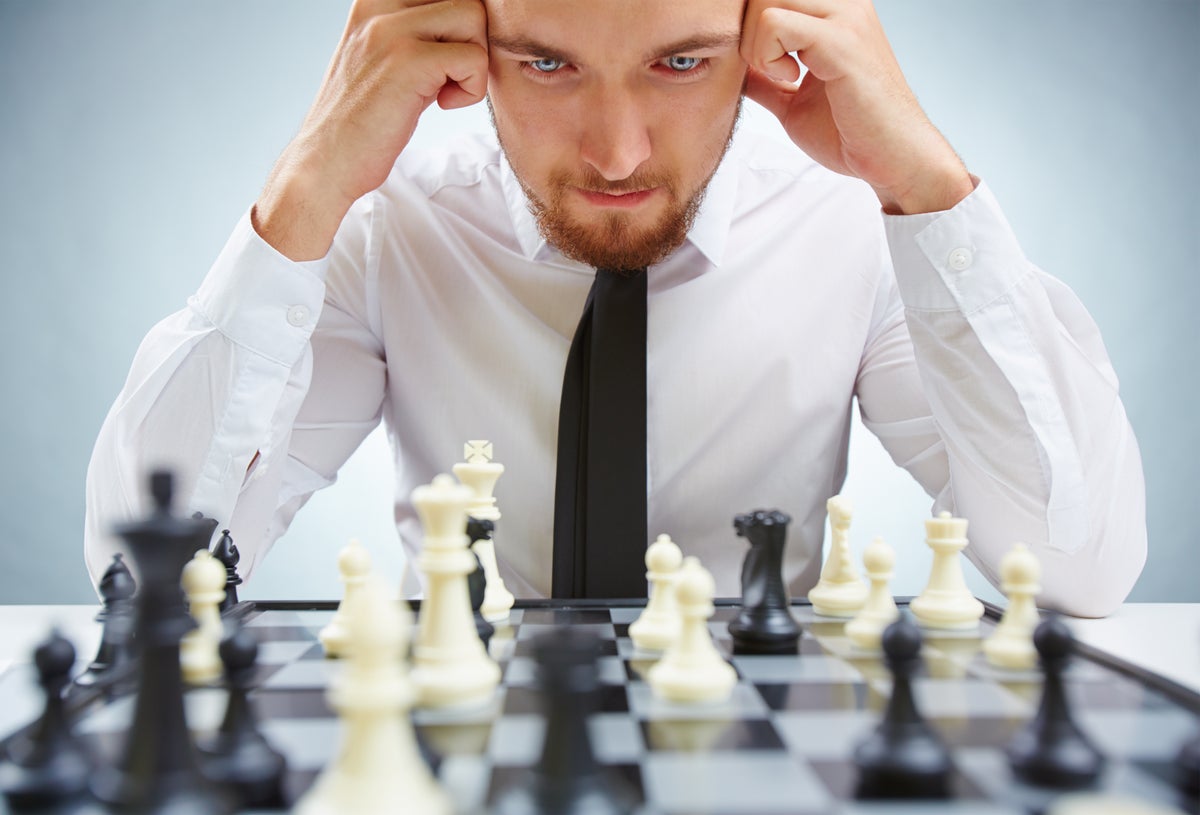 Male chess player with figures in the eyes, thinking process