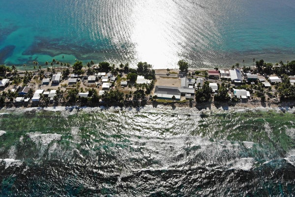Homes on a strip of land endangered by sea rise.