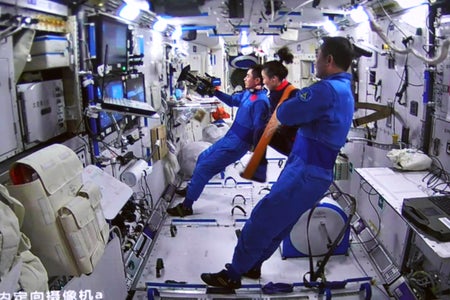 Screen image taken at Beijing Aerospace Control Center on March 27, 2022 shows the Shenzhou-13 astronauts watching the Tianzhou-2 cargo spacecraft leaving the core module of China's Tiangong space station.