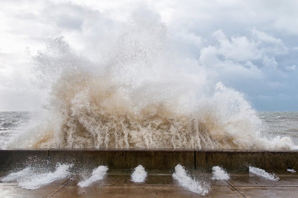 Massive wave hits sea wall, bursting through concrete holes at its base