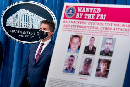 An FBI Most Wanted poster is displayed at a White House press briefing