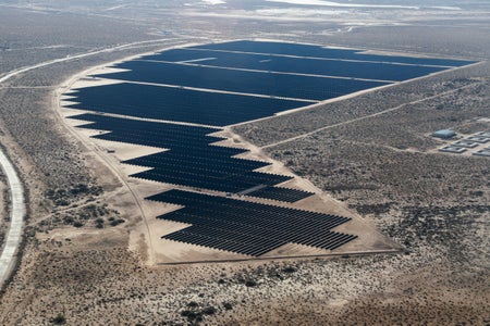 Aerial view of solar panels winding in deserted area