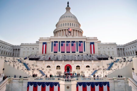 The sun rises behind the US Capitol as preparations are made prior to the 59th inaugural ceremony for President-elect Joe Biden and Vice President-elect Kamala Harris on the West Front of the US Capitol in Washington, DC on January 20, 2021.