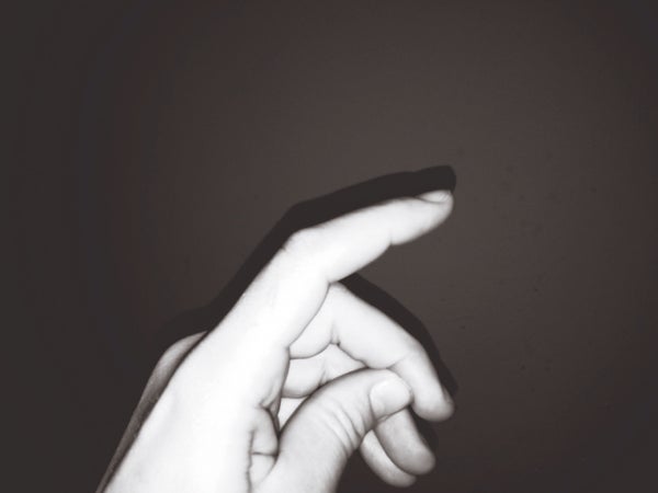 A black and white close up of a hand with fingers mid-snap