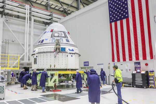 Boeing's Starliner spacecraft is moved to a hazardous processing area at its hangar at NASA's Kennedy Space Center in Florida.