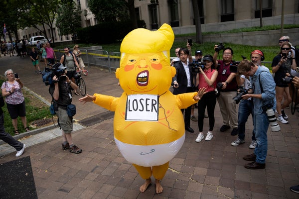 Person in Inflatable Donald Trump costume that resembles a baby wearing diapers