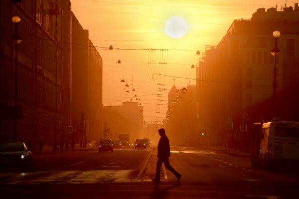 Silhouette Of Man In City At Sunset