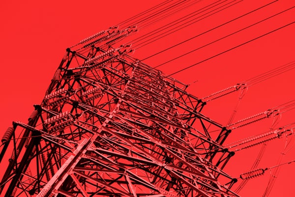 Close-up of high voltage pole on red background.