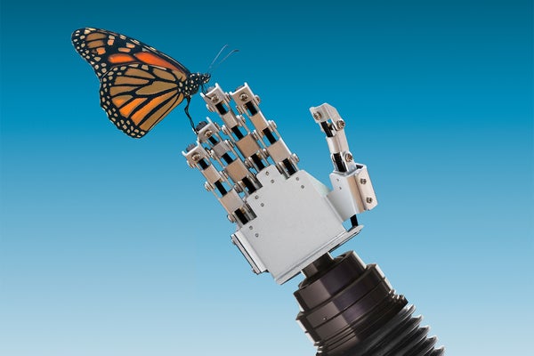 A butterfly rests on a robot hand