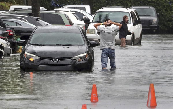 Stranded drivers in flooded parking lot