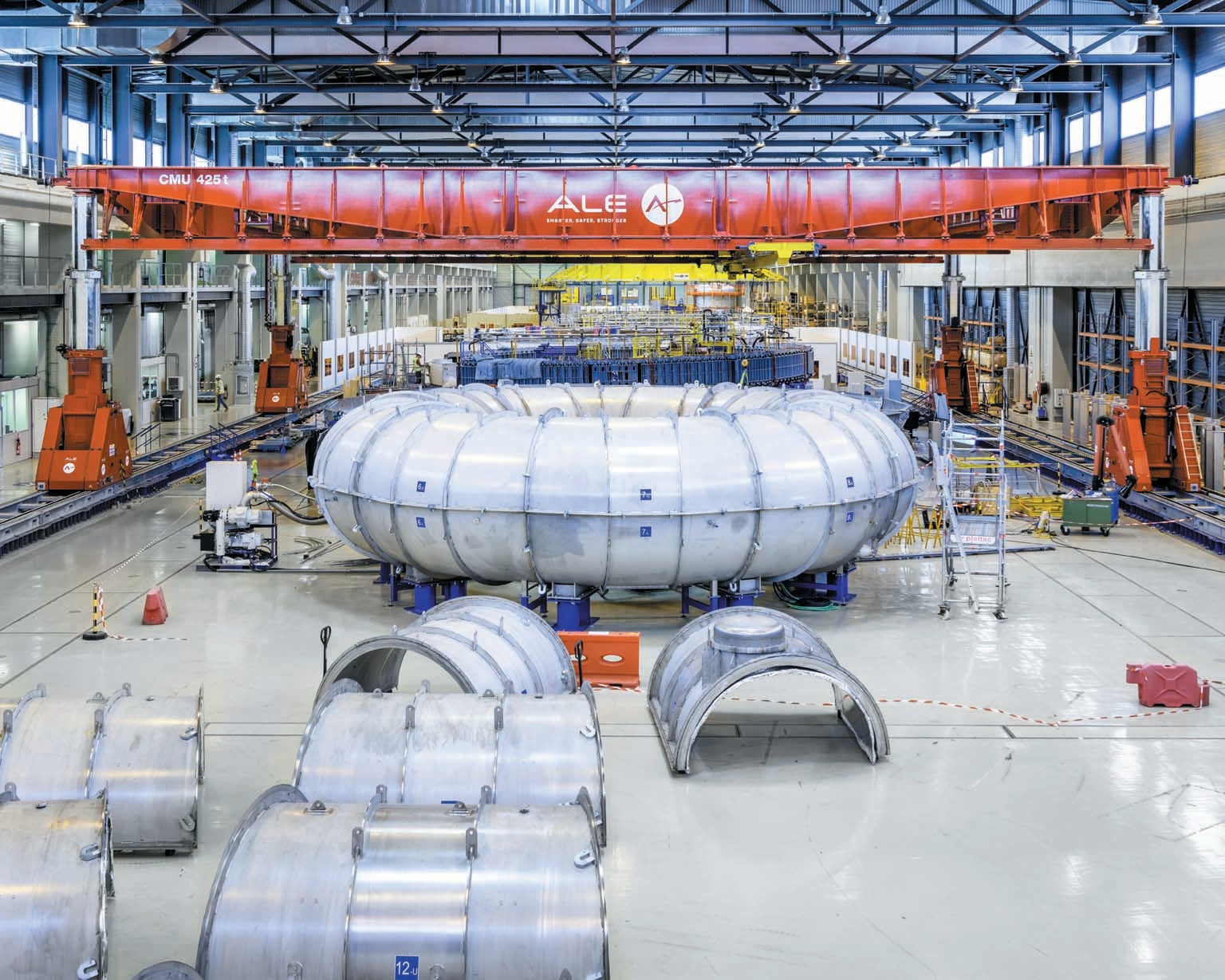 Large metallic industrial equipment in industrial warehouse space.