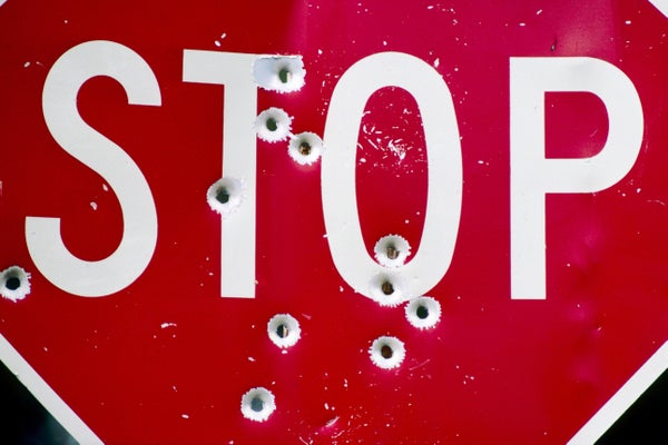Stop sign riddled with bullet holes