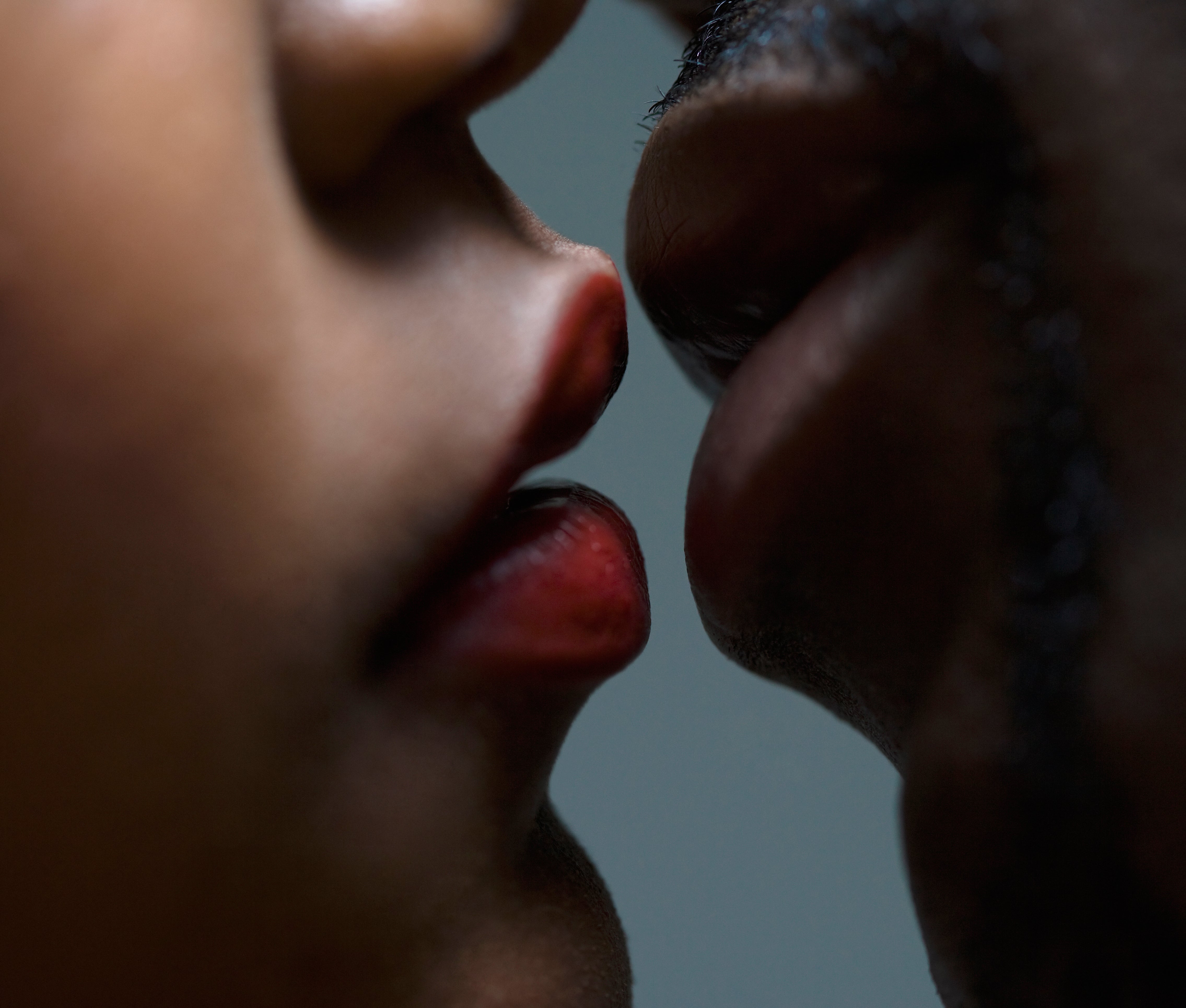wife kissing black friend