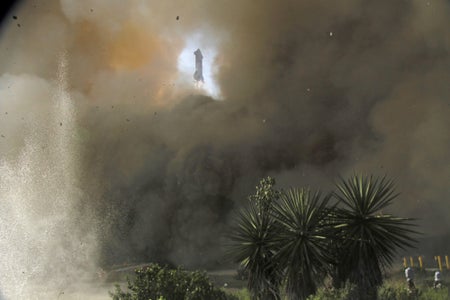 SpaceX rocket seen through small opening of exhaust and debris
