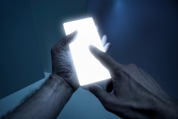 Man holding a glowing smart phone