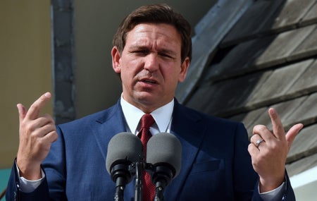 Florida Gov. Ron DeSantis speaks in front of microphone