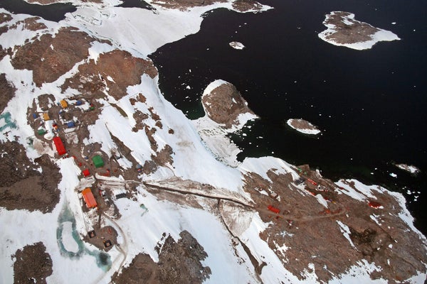 Aerial view of the Australian Antarctic research station partially snow covered showing roads and buildings