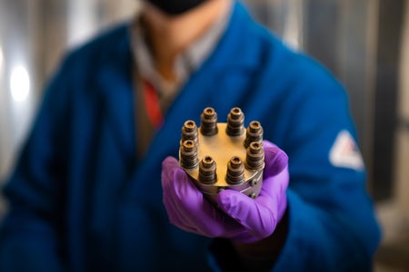 Close-up view of hand holding a battery.