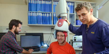 Neuroscientist Abraham Zangen (right) and two of his students with an early version of their repetitive transcranial magnetic stimulation system.