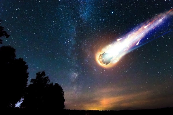 A comet falls to the Earth against a starry sky.