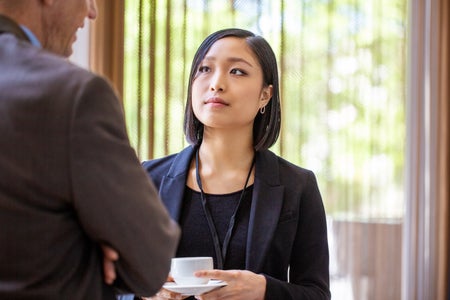 Businesswoman talking with male colleague.